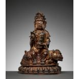 A GILT-LACQUERED BRONZE FIGURE OF MANJUSHRI SEATED ON A LION, MING DYNASTY