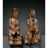 A PAIR OF GILT-LACQUERED HARDWOOD FIGURES OF DAOIST IMMORTALS, MING DYNASTY