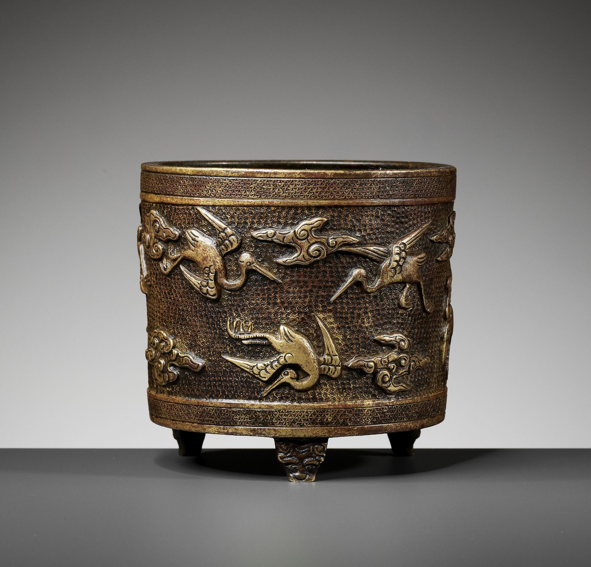 A HU WENMING PARCEL-GILT TRIPOD CENSER, MING DYNASTY