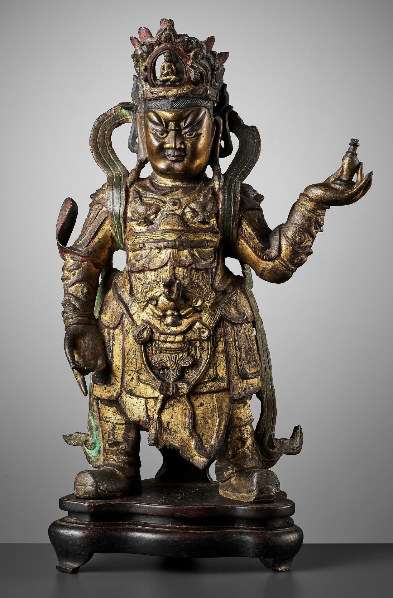 A VERY LARGE GILT BRONZE OF GUANGMU TIANWANG, THE GUARDIAN-KING VIRUPAKSHA, MING DYNASTY