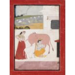 AN INDIAN MINIATURE PAINTING OF KRISHNA MILKING A COW