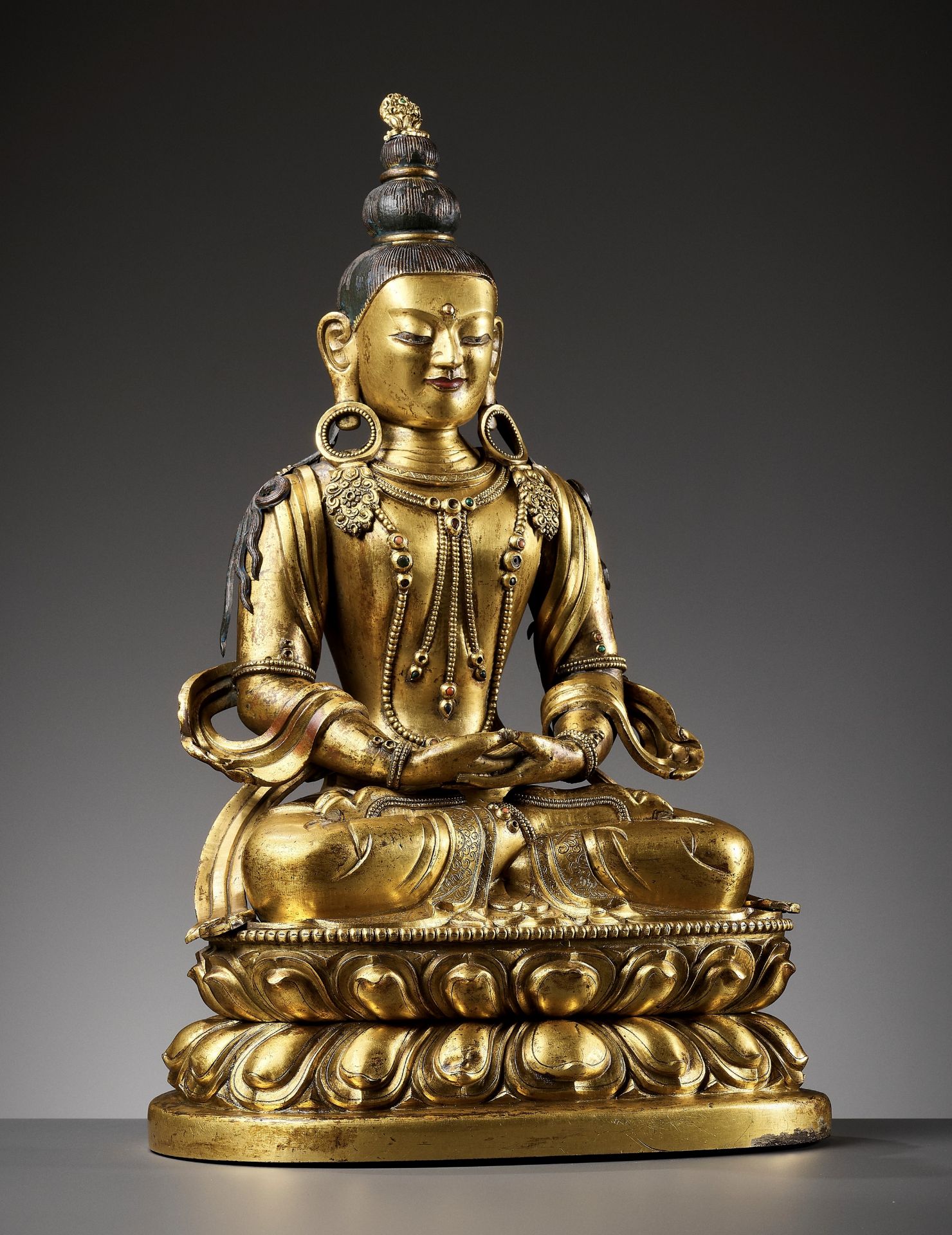 A CAST AND REPOUSSE GILT COPPER ALLOY FIGURE OF AMITAYUS, QIANLONG PERIOD