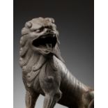 A SUPERBLY CARVED LIMESTONE FIGURE OF A LION, TANG DYNASTY