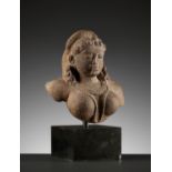 A PINK SANDSTONE BUST OF A CELESTIAL DEITY