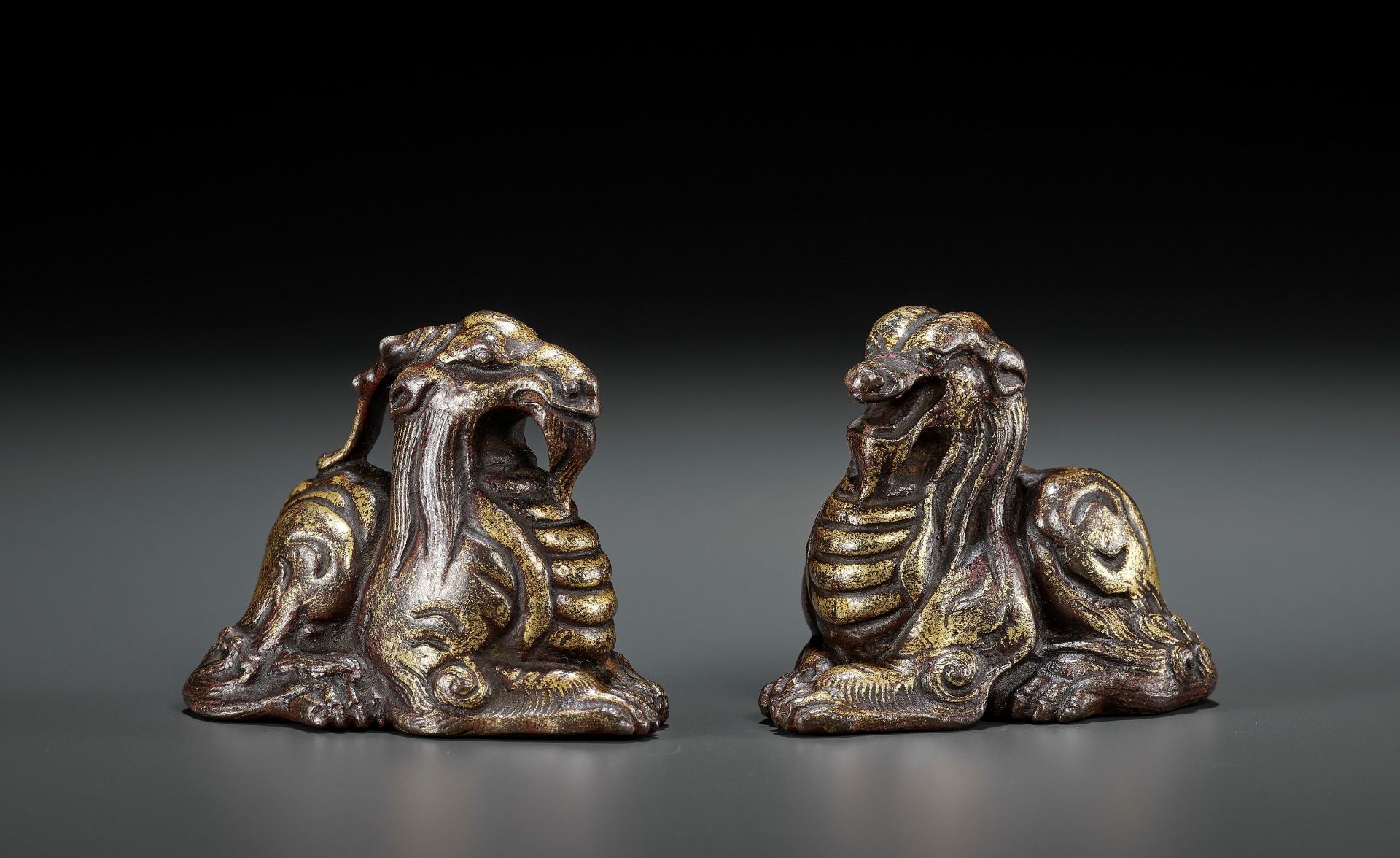 A PAIR OF GILT BRONZE 'MYTHICAL BEAST' WEIGHTS, EASTERN ZHOU TO WESTERN HAN