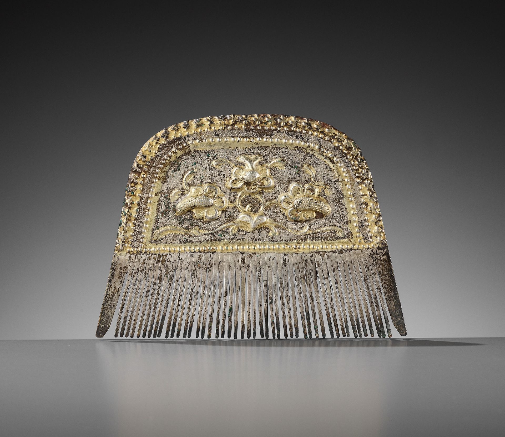 A PARCEL-GILT SILVER COMB, TANG DYNASTY