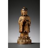 A RARE GILT BRONZE FIGURE OF A BUDDHIST DISCIPLE, POSSIBLY ANANDA, MING DYNASTY