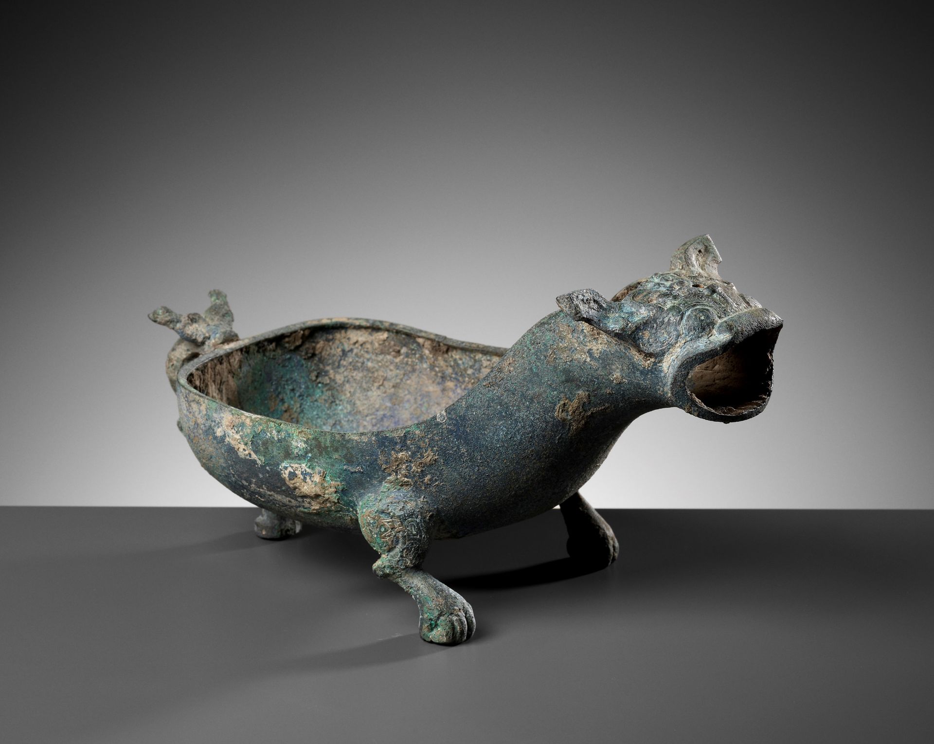 A RARE BRONZE 'ROARING BULL' POURING VESSEL, YI, SPRING AND AUTUMN PERIOD