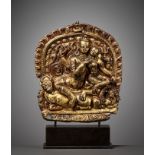 A GILT COPPER ALLOY REPOUSSE PLAQUE DEPICTING UMAMAHESHVARA