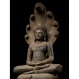 A MONUMENTAL SANDSTONE FIGURE OF BUDDHA MUCHALINDA, ANGKOR PERIOD