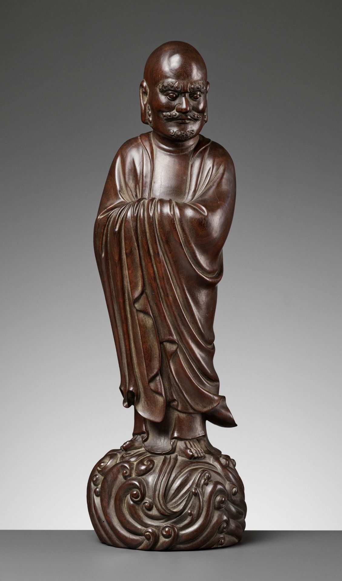 A LARGE HARDWOOD FIGURE OF DAMO (BODHIDHARMA), LATE MING TO EARLY QING DYNASTY