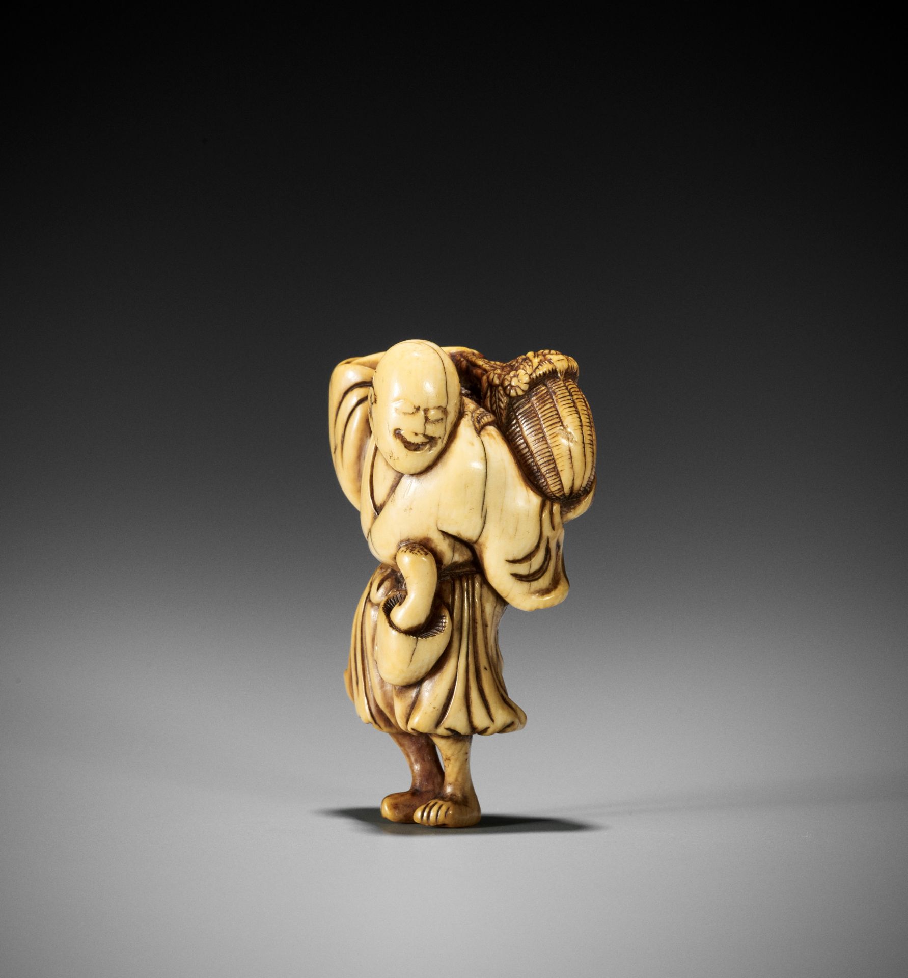 A KYOTO SCHOOL IVORY NETSUKE OF A FARMER GATHERING FLOWERS AND MUSHROOMS