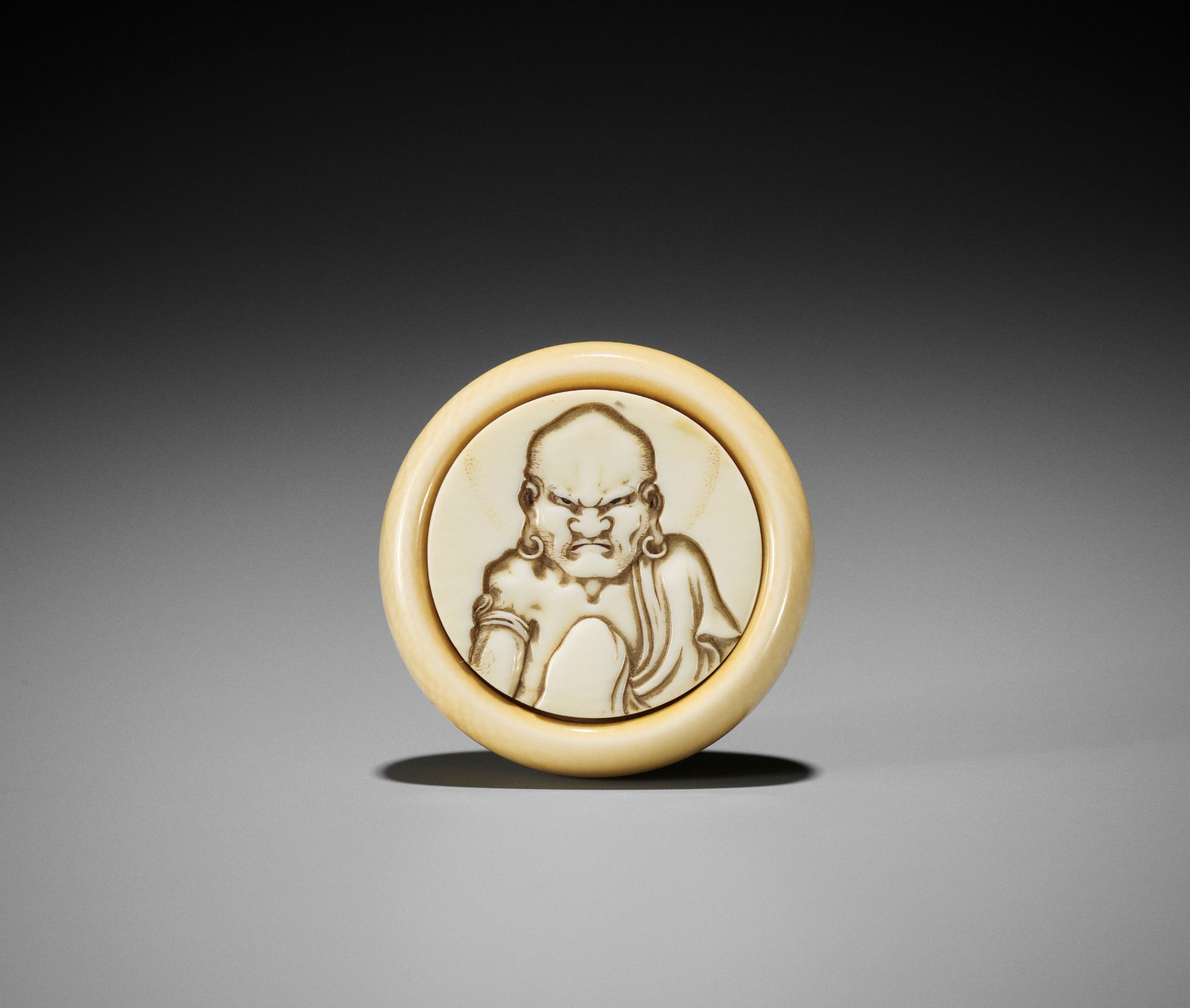 HOJITSU: A FINE IVORY KAGAMIBUTA NETSUKE WITH A RAKAN