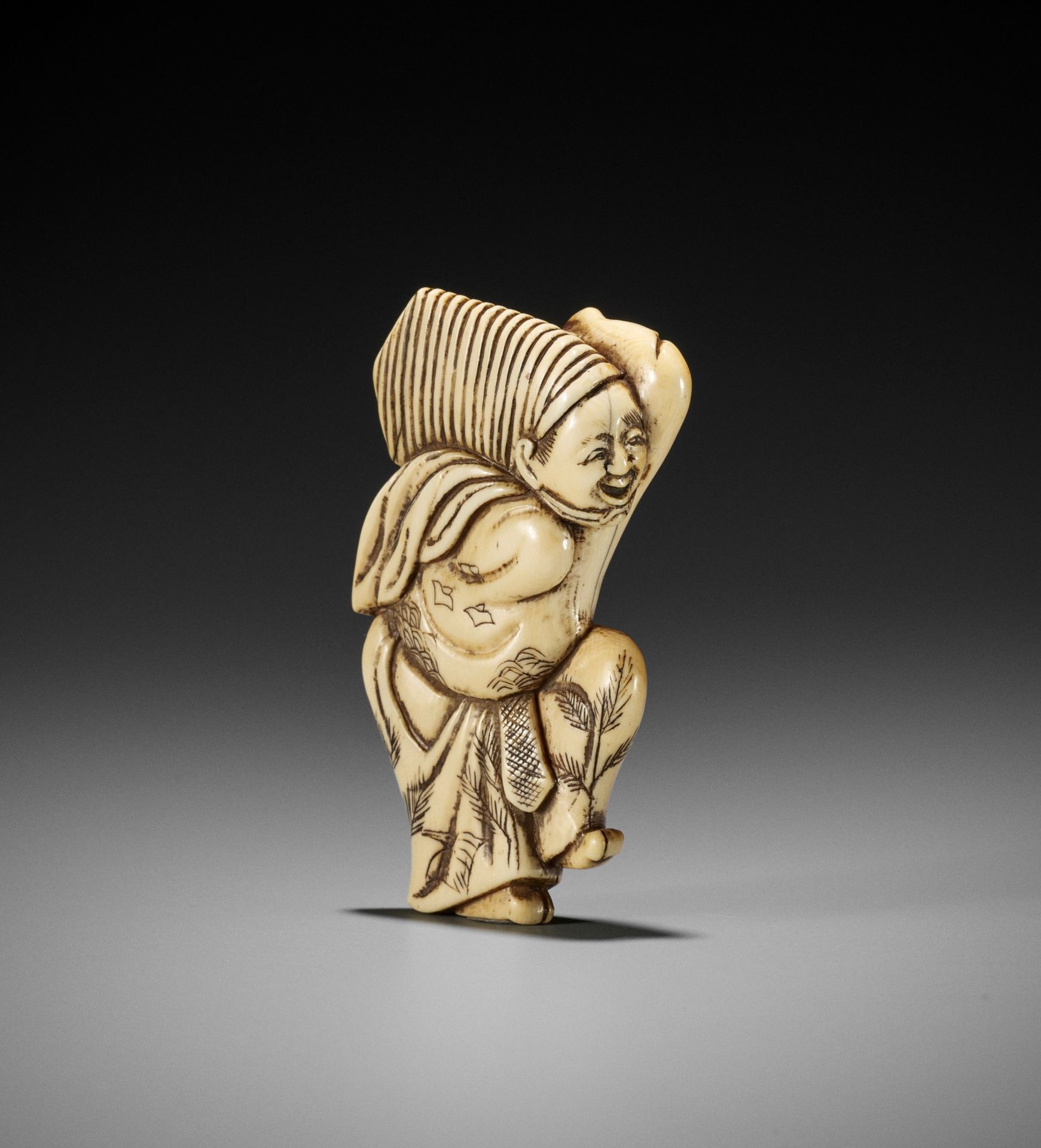 AN EARLY IVORY NETSUKE OF A SAMBASO DANCER