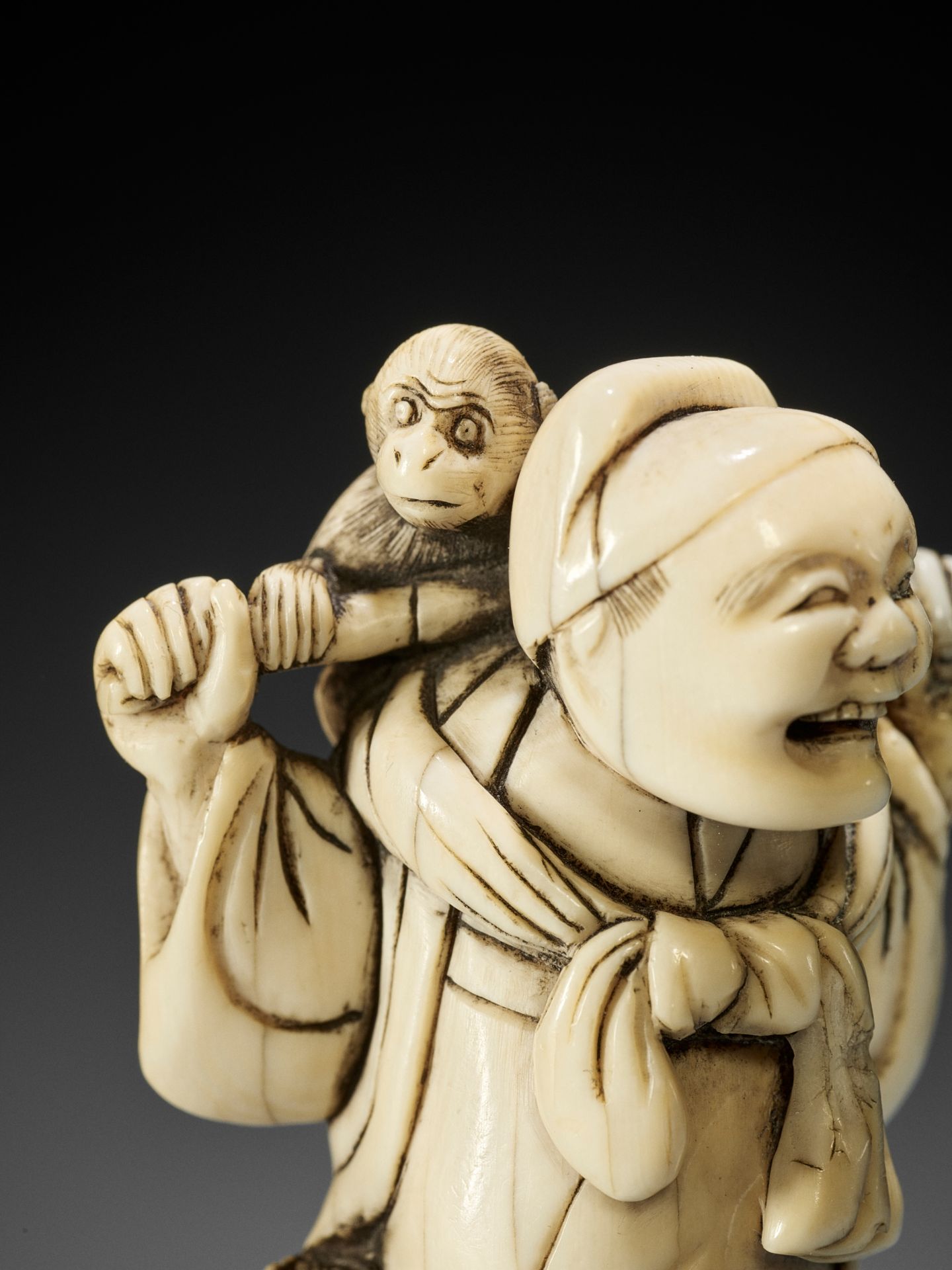 AN IVORY NETSUKE OF A SARUMAWASHI WITH MONKEY - Bild 2 aus 9