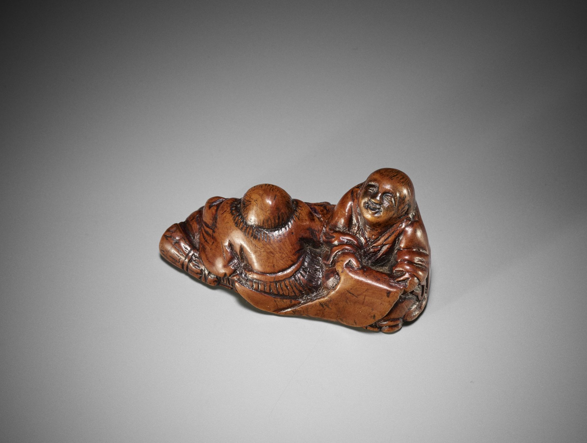 A WOOD NETSUKE OF KANZAN AND JITTOKU