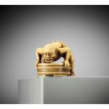 A VERY RARE IVORY NETSUKE OF A MAN WITH A COIN IN HIS MOUTH