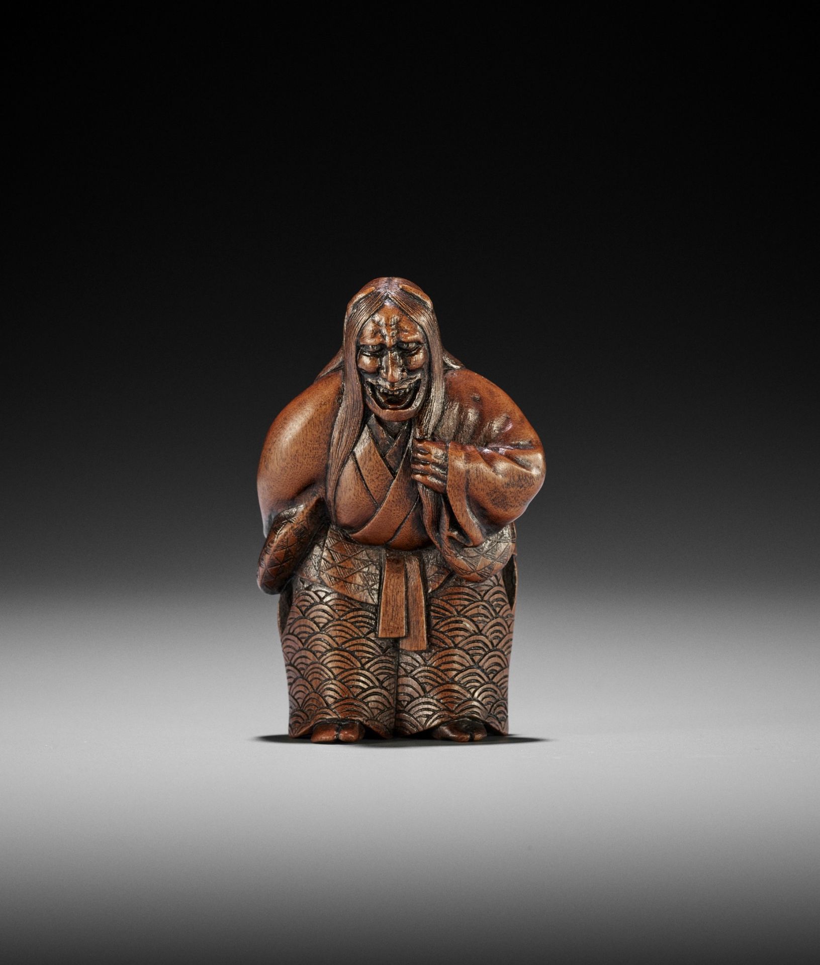 A POWERFUL WOOD NETSUKE OF KIYOHIME