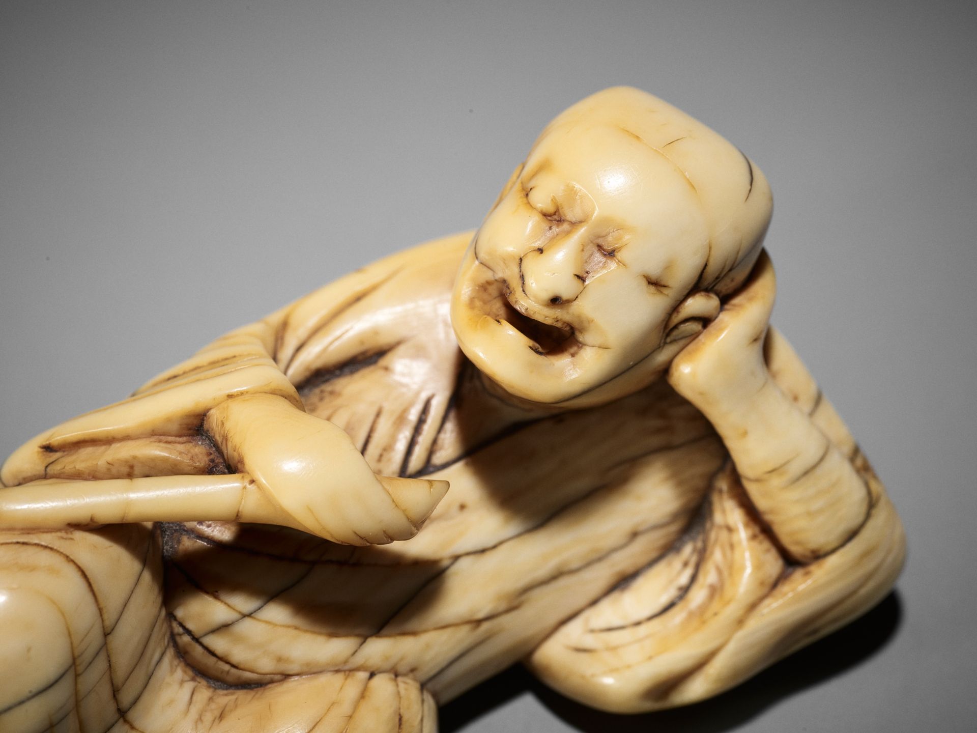 A RARE AND LARGE IVORY NETSUKE OF A RECLINING SARUMAWASHI AND HIS MONKEY - Bild 2 aus 10