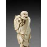 A GOOD IVORY NETSUKE OF A STREET VENDOR