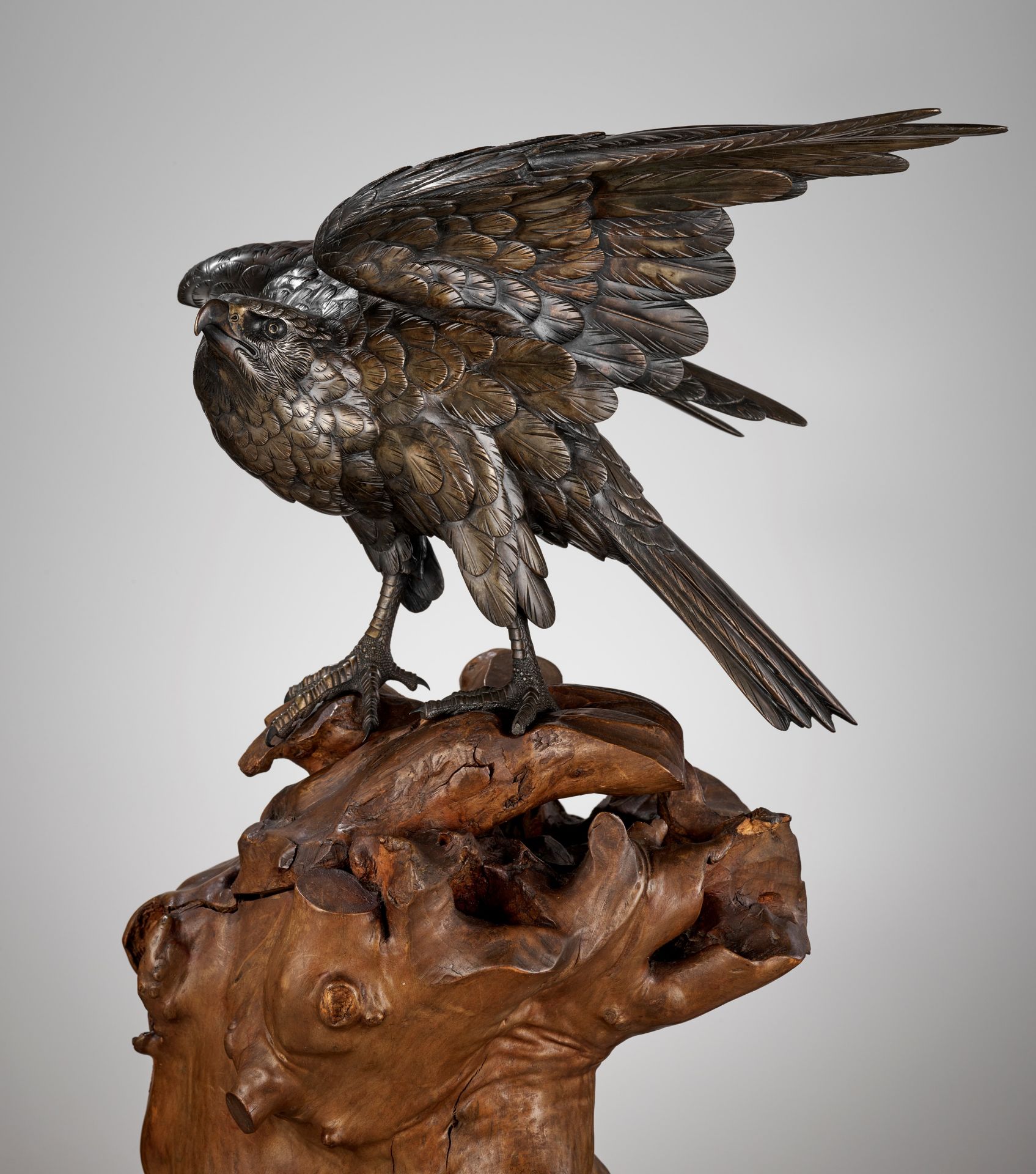 GYOKKO: A FINE BRONZE OKIMONO OF AN EAGLE ON A ROOTWOOD STAND