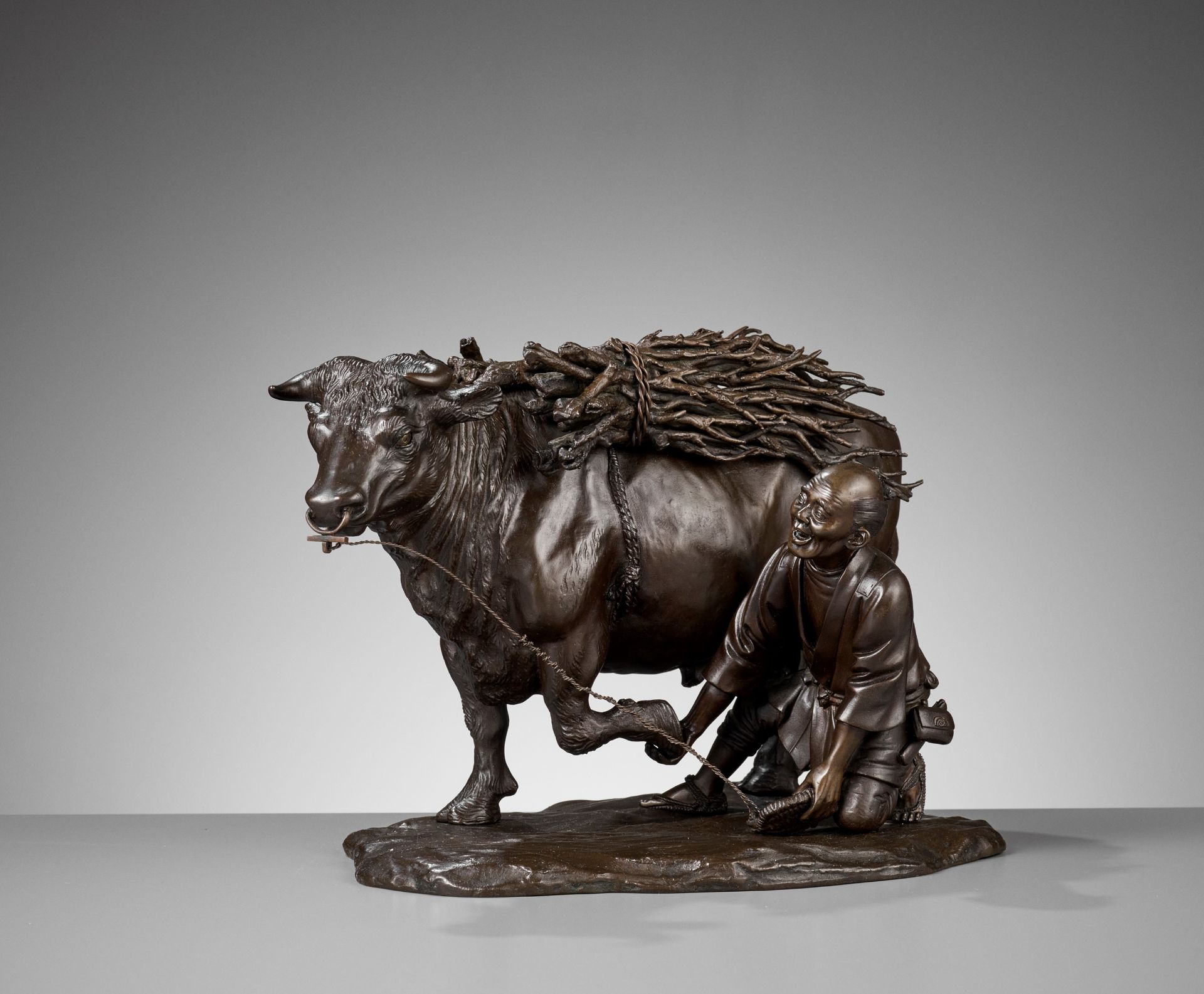 AKASOFU GYOKKO: A FINE AND LARGE BRONZE MODEL OF AN OX AND OXHERD