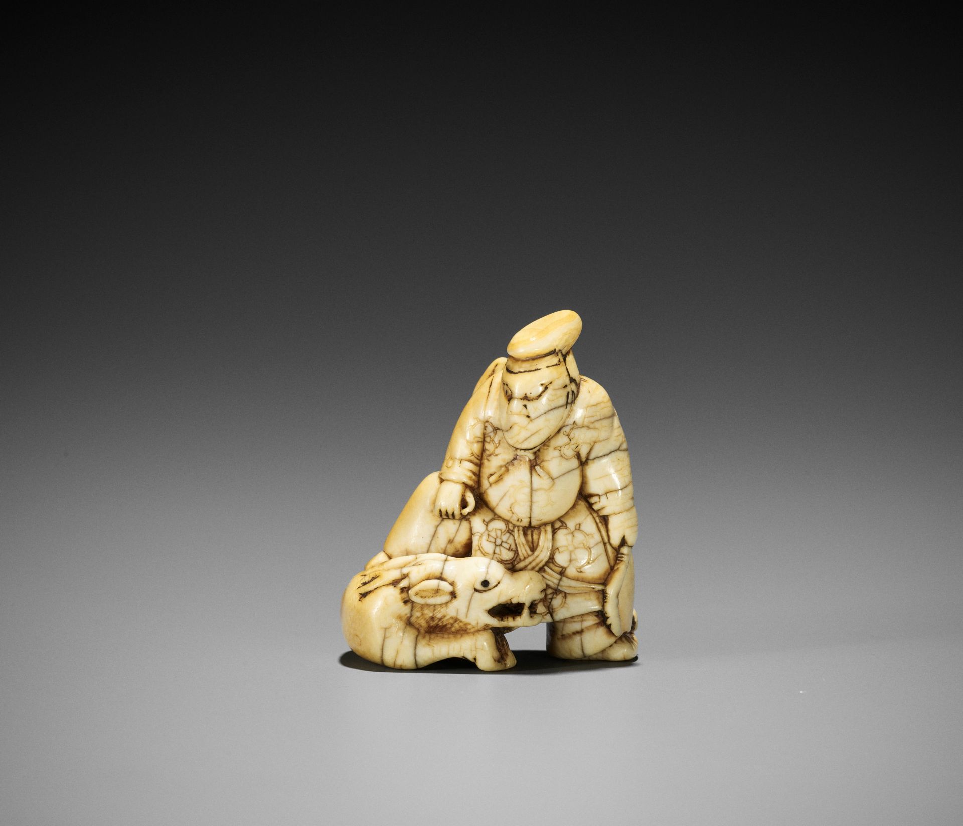 ISSHU: A POWERFUL IVORY NETSUKE OF ROKUSONO TSUNEMOTO KILLING THE DEER