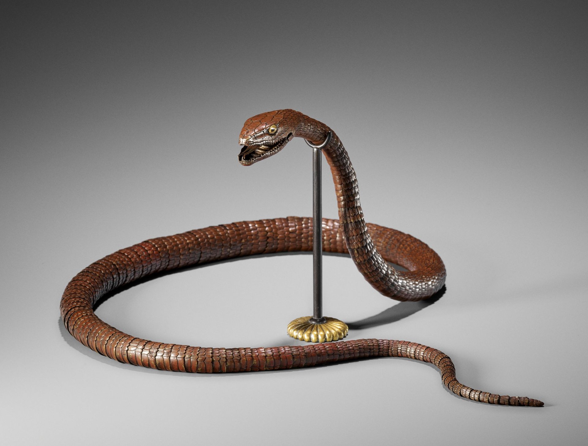 A RARE AND IMPRESSIVE PATINATED BRONZE ARTICULATED MODEL OF A SNAKE