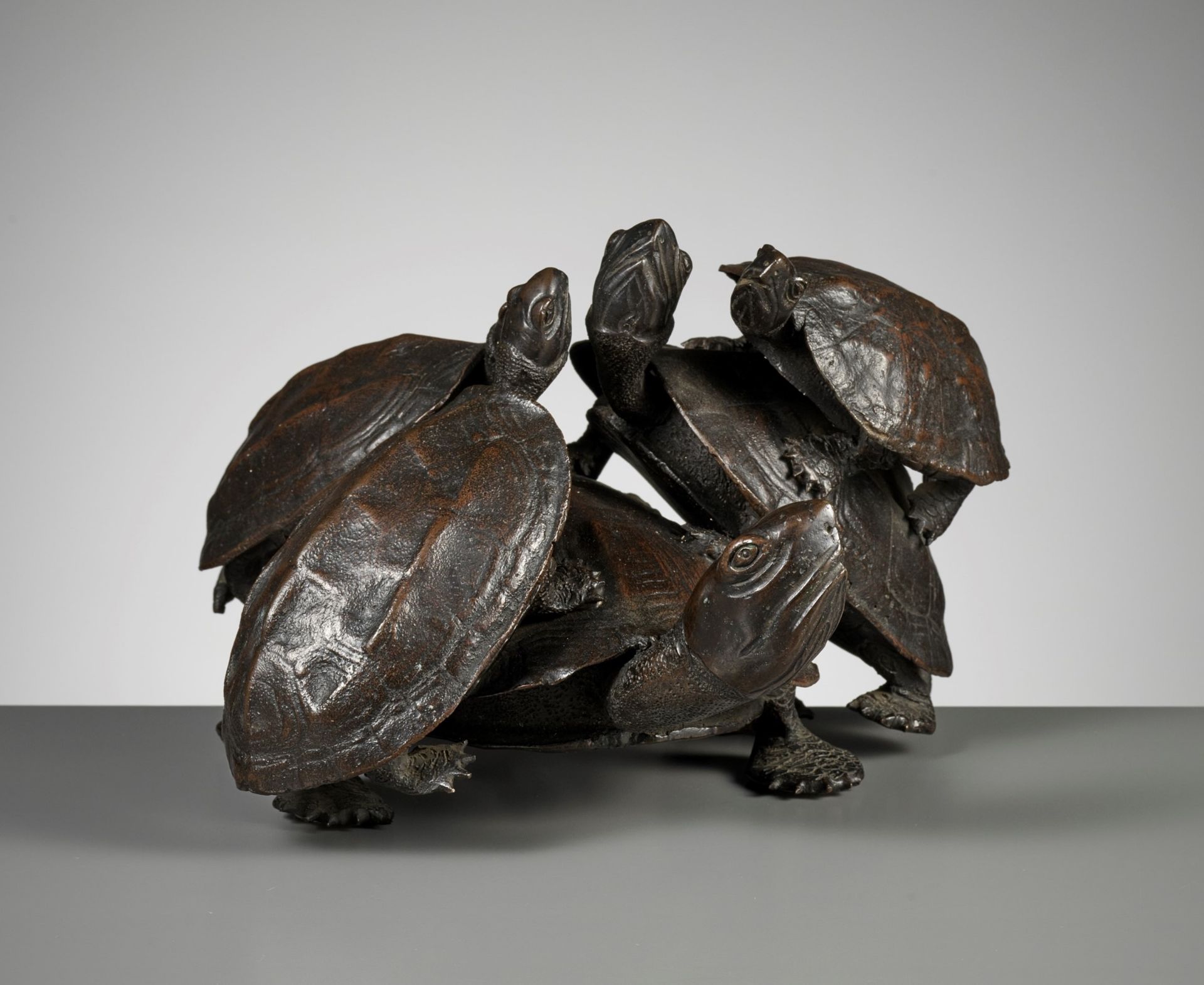 A LARGE BRONZE OKIMONO OF FIVE TURTLES