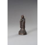 A MINIATURE BRONZE FIGURE OF A MONK, EARLY QING DYNASTY