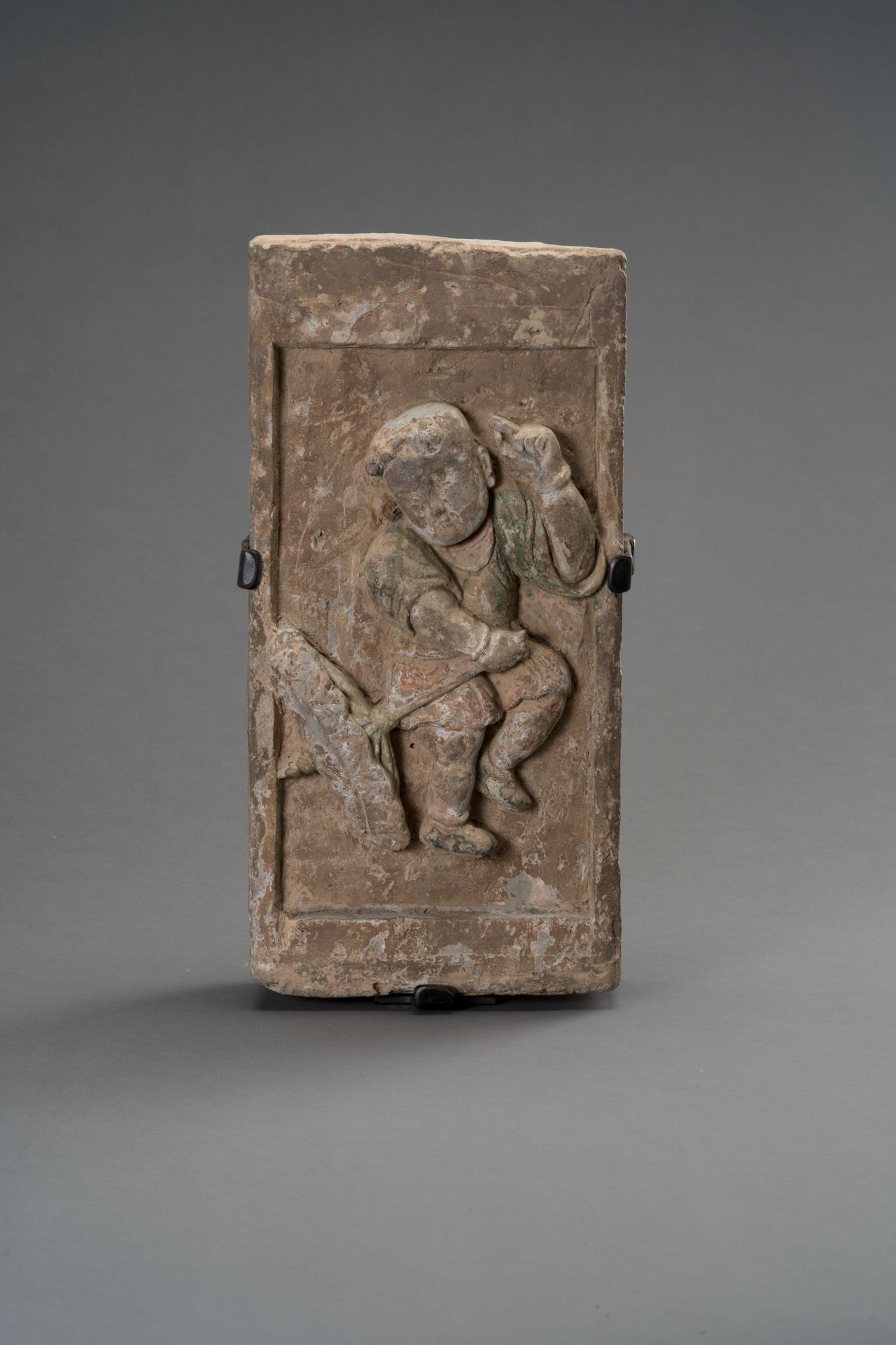 A TERRACOTTA WALL BRICK DEPICTING A CHILD WITH UMBRELLA, SONG DYNASTY