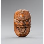 HOZAN: A LARGE WOOD NETSUKE OF A BAKEMONO MASK