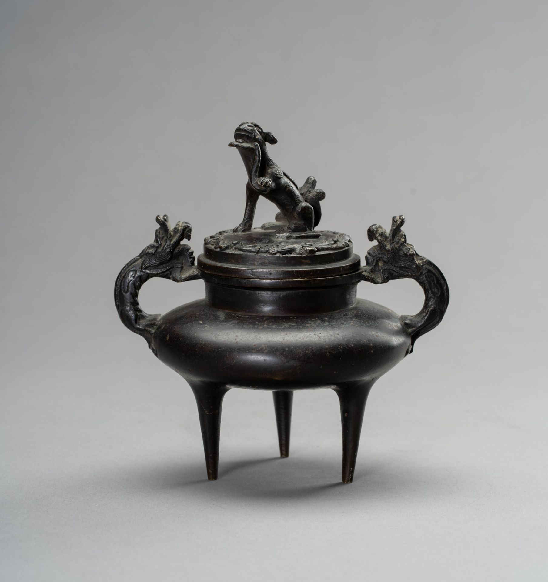 A MINIATURE BRONZE 'BUDDHIST LION' TRIPOD CENSER, QING DYNASTY