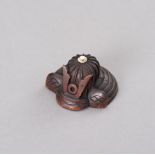 A WOOD NETSUKE OF A KABUTO