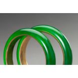 A PAIR OF GLASS IN IMITATION OF JADEITE BANGLES