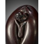 A RARE WOOD SHUNGA NETSUKE DEPICTING A MONK IN A VULVA