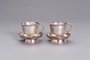 A PAIR OF SILVER CUPS WITH MATCHING SAUCERS