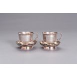 A PAIR OF SILVER CUPS WITH MATCHING SAUCERS