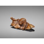 SEIYODO TOMIHARU: A RARE WOOD NETSUKE OF A SNAIL ON A TARO LEAF