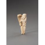 AN IVORY NETSUKE OF A MAN WITH SCROLL