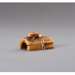 MUNEMITSU: AN IVORY NETSUKE OF A FROG ON BAMBOO