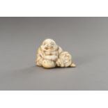 AN IVORY NETSUKE OF HOTEI WITH HIS TREASURE BAG