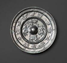 A SILVERED BRONZE 'MYTHICAL BEASTS' MIRROR, TANG DYNASTY