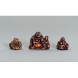 A GROUP OF THREE WOOD NETSUKE OF HOTEI AND KARAKO