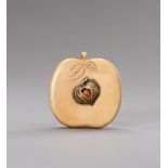 A RESIN NETSUKE IN THE SHAPE OF A PEACH