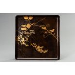 A FINE BROWN LACQUER TRAY WITH LEAFY SPRAYS