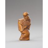 A WOOD NETSUKE OF AN ACTOR WITH FAN