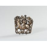 A PARCEL GILT SILVER REPOUSSE ORNAMENT OF GUANYIN ON A BUDDHIST LION