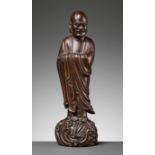 A LARGE HARDWOOD FIGURE OF DAMO (BODHIDHARMA), LATE MING TO EARLY QING DYNASTY