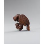 A BOXWOOD 'EAGLE SNATCHING MONKEY' NETSUKE